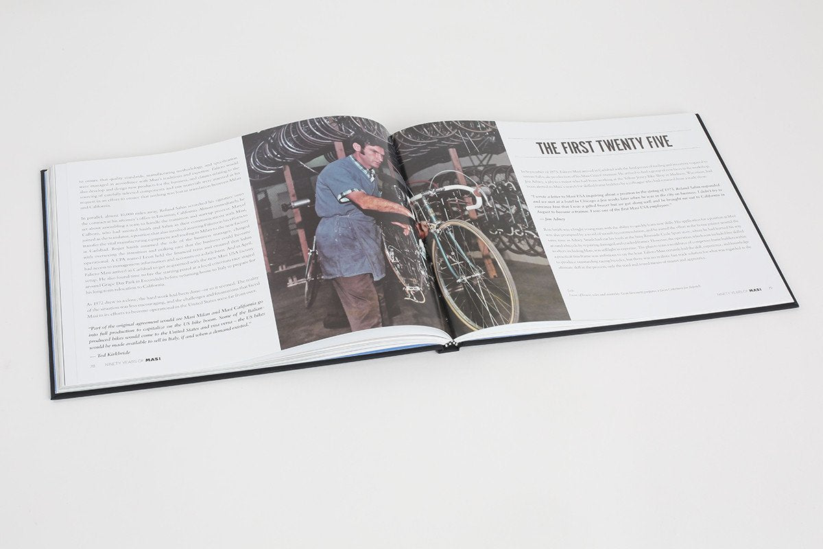 An open book shows a black-and-white photo of someone assembling a bicycle, reflecting Masi Bikes craftsmanship. The opposite page, entitled The First Twenty Five, explores the rich history of bicycles through engaging narratives in 90 YEARS OF MASI.