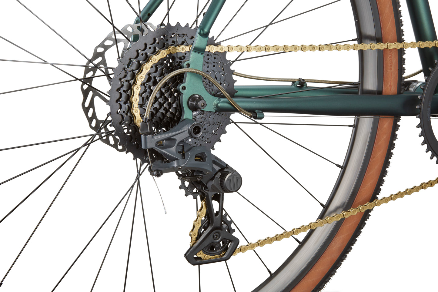 Close-up of CATALINA 2s rear wheel with gears, gold chain, derailleur, and disc brake—perfect for city rides.