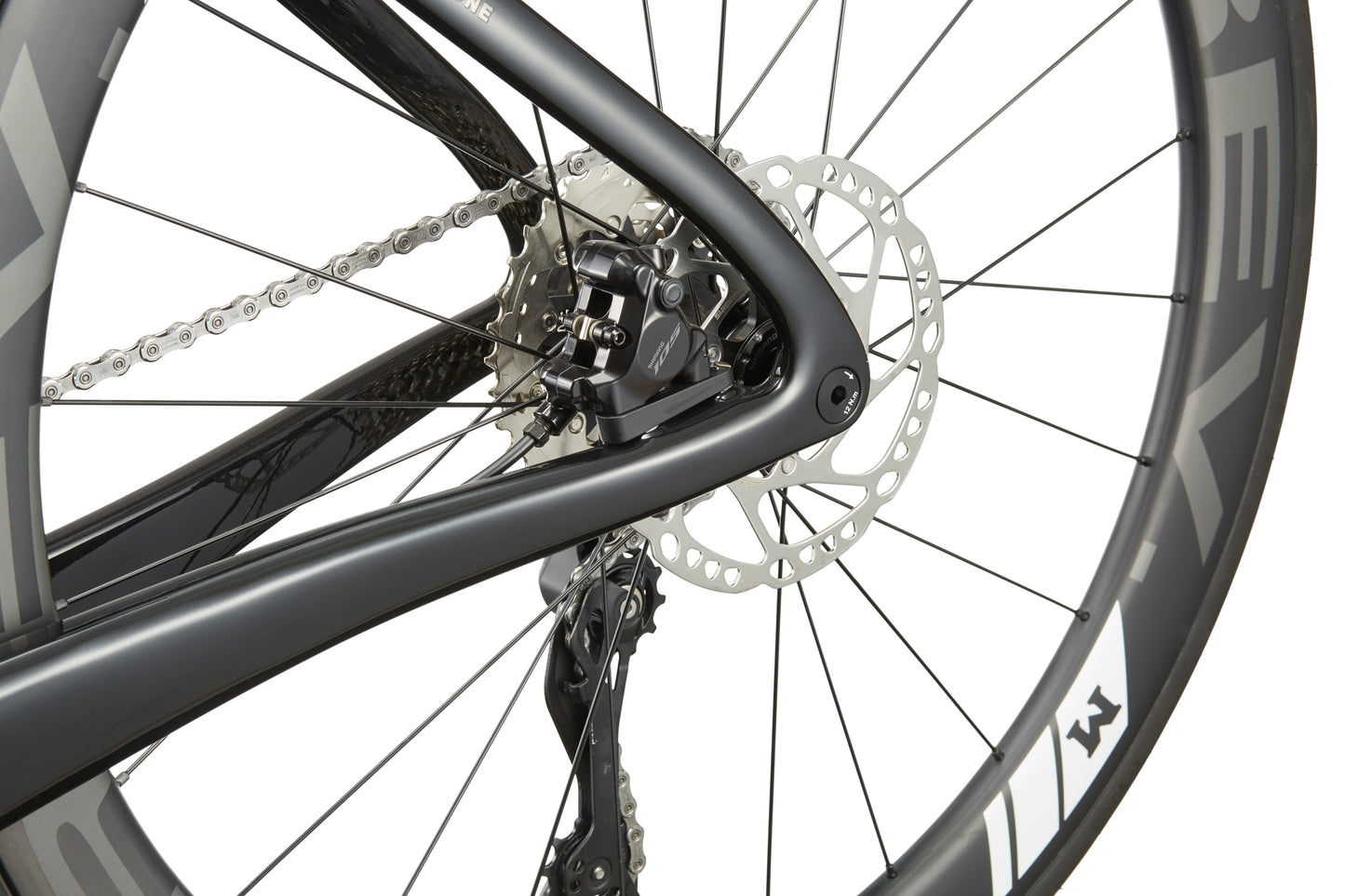 Close-up of an EVOLUZIONE 1 rear wheel highlighting its sleek frame, chain, and disc brake, exemplifying modern aerodynamic design.