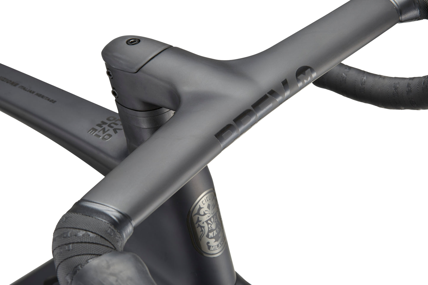 Close-up of the EVOLUZIONE 1 bike with a matte gray carbon frame, black handlebars, aerodynamic design, and a stylized lions head logo.