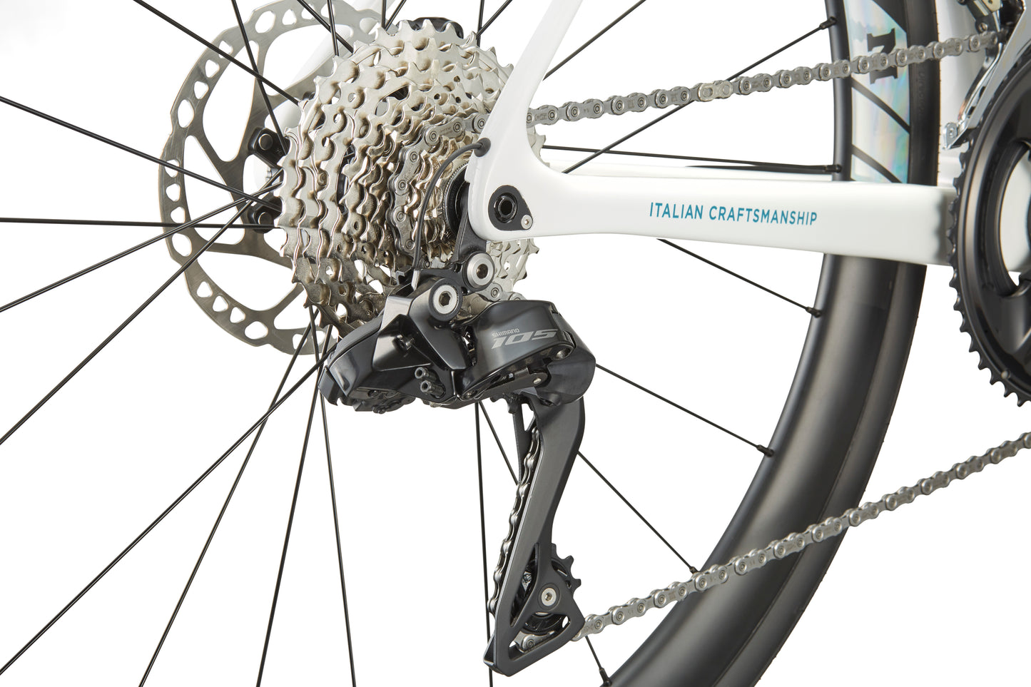 Close-up of GRAN CORSA carbon road bike’s rear derailleur, gears, and disc brake with Italian Craftsmanship on the frame.