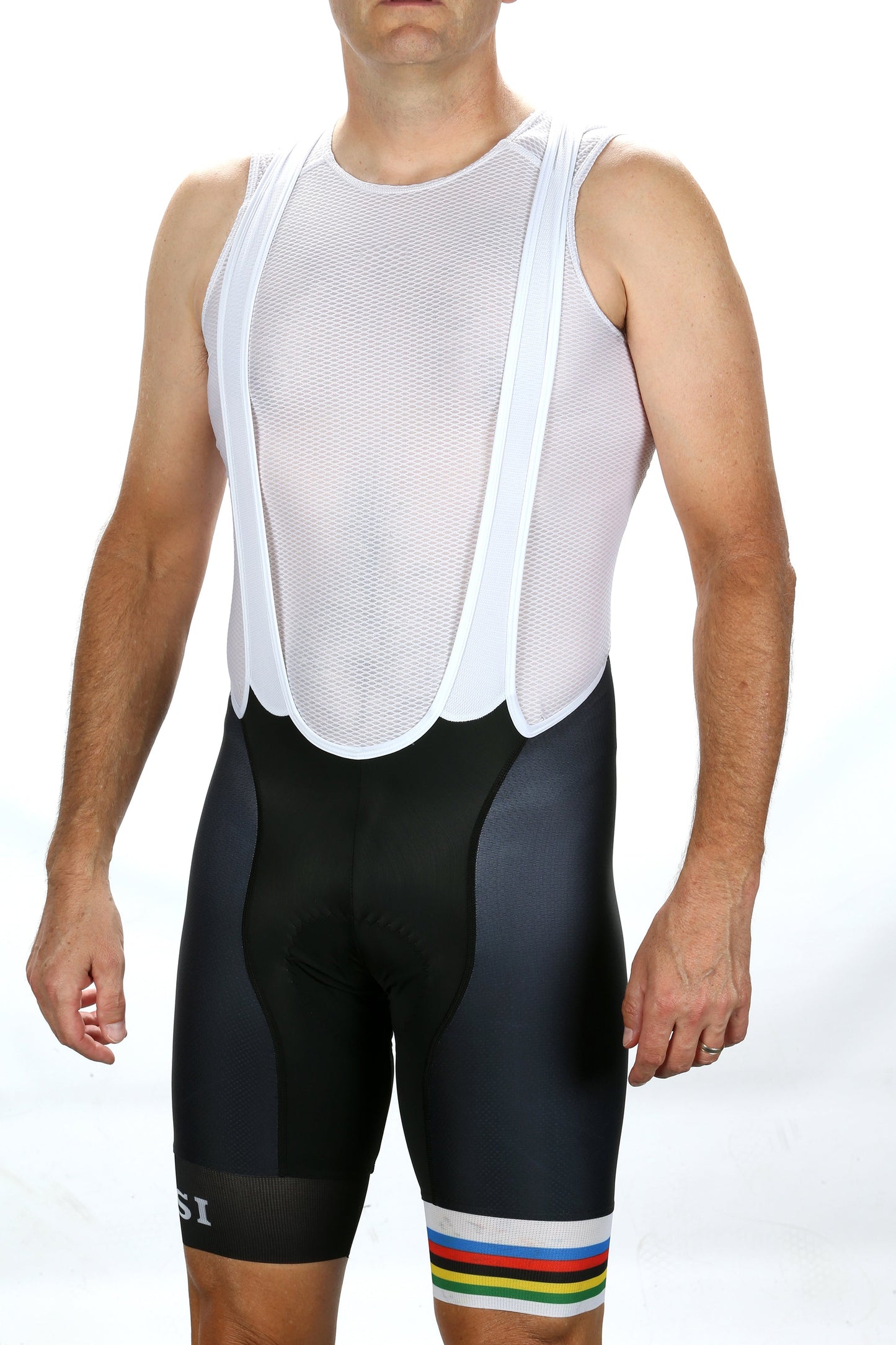 A person in a white mesh sleeveless cycling jersey and Masi Bikes MASI LEGACY BIBS, featuring black aero race design with rainbow stripes near the hem, stands against a white background.