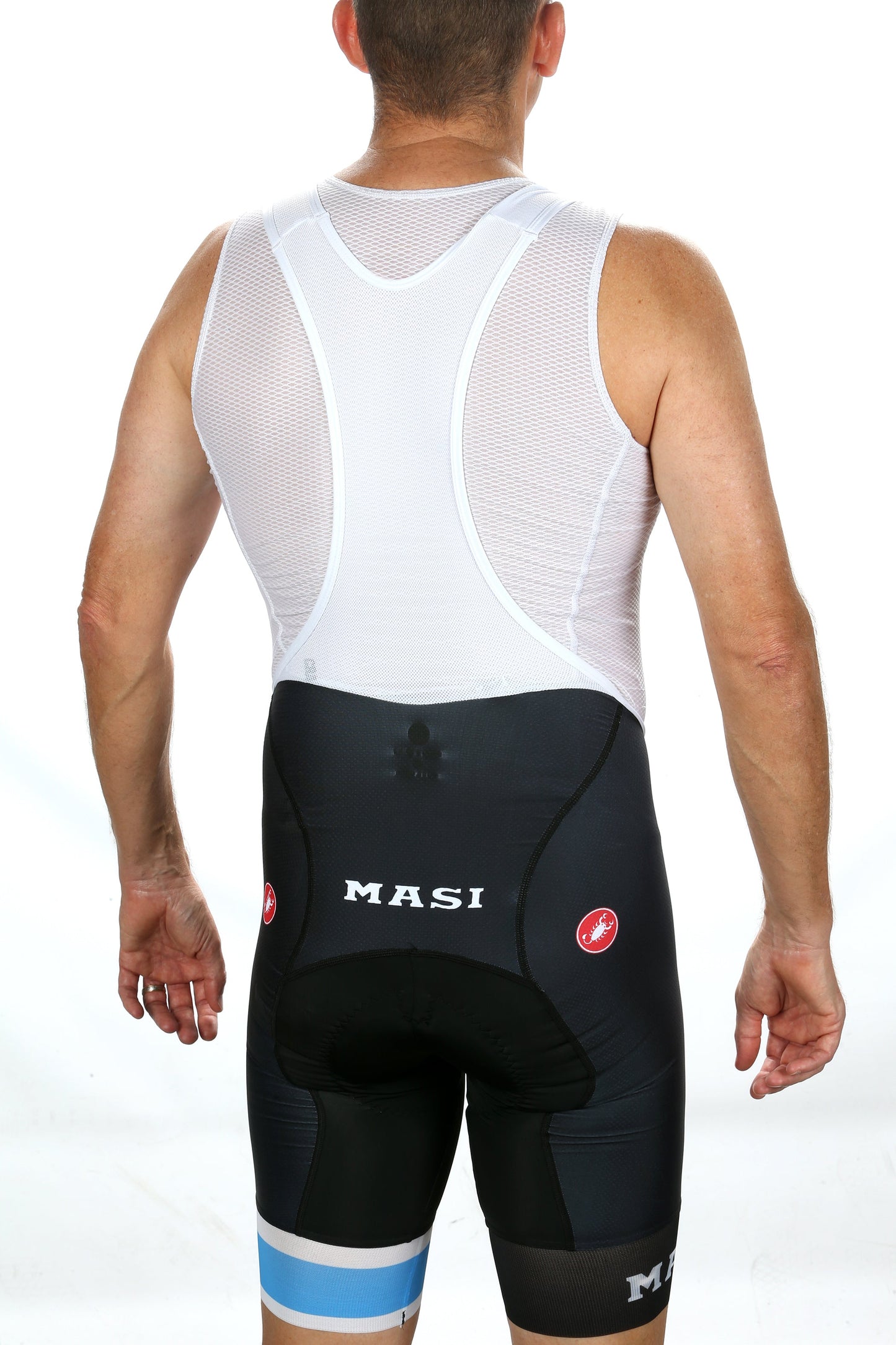A man, facing away from the camera, dons a white sleeveless athletic top and MASI LEGACY CX BIBS by Masi Bikes. The sleek design signifies his commitment to aerodynamics, with a plain white background emphasizing streamlined efficiency.
