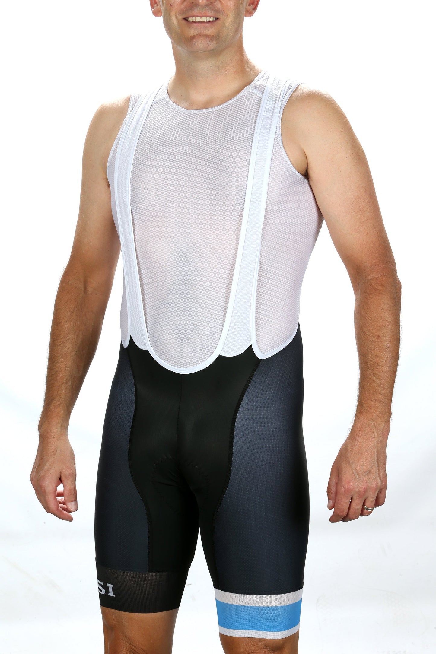 A man in sleeveless white mesh cycling jersey and MASI LEGACY CX BIBS from Masi Bikes, with blue and white accents, stands against a plain white background, showcasing the superior aerodynamics. His arms relaxed by his sides emphasize comfort and style.