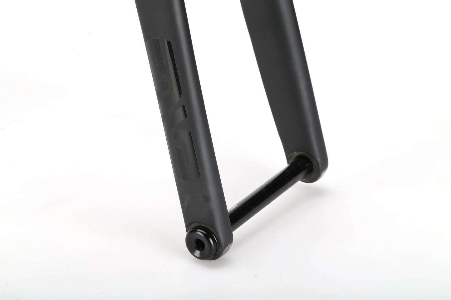 Close-up of the black fork from a Masi Bikes TITANIO FRAMESET, showcasing its sleek matte finish and cylindrical tube for wheel axle attachment, with 32c tire clearance, set against a plain white background.