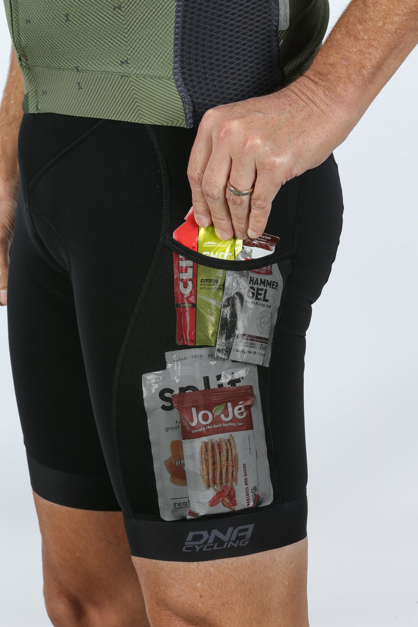 They reach into the back pocket of their MASI DNA GRAVEL BIB, crafted by Masi Bikes for optimal comfort and ergonomic fit, to grab energy gel packets labeled JoJe, Skratch, GU, and Hammer Gel.
