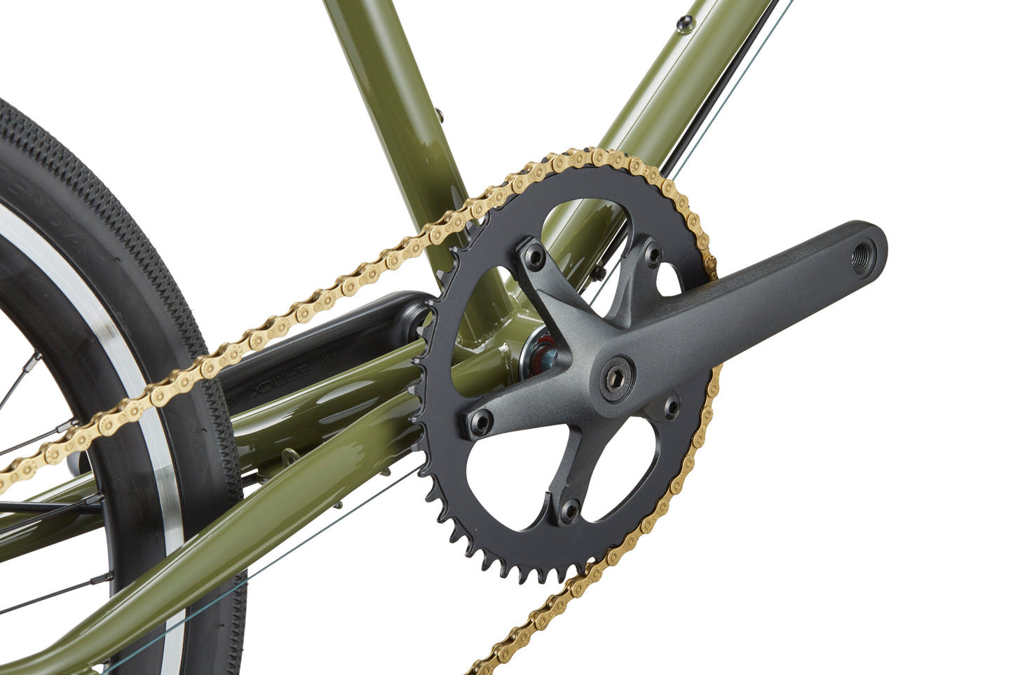 Close-up of STELVIO 2s crankset, chainring, and golden chain on a green MiniVelo frame with Italian design flair.