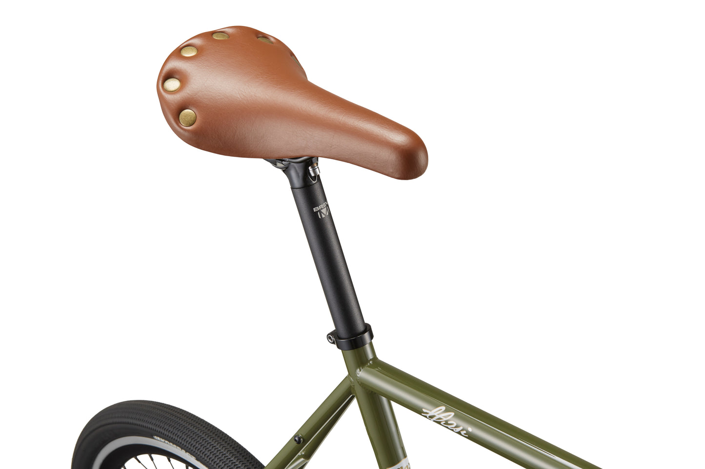 Close-up of the STELVIO 2 brown leather MiniVelo seat with brass rivets on a green frame against a white background.