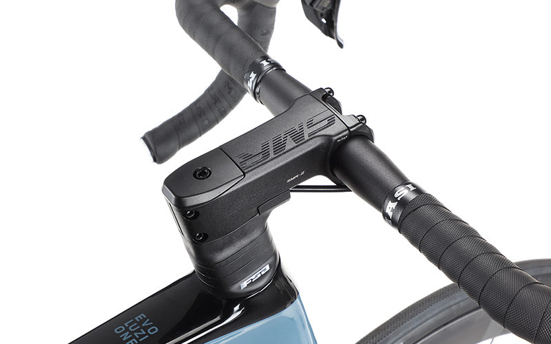 Close-up of the EVOLUZIONE 1s handlebars and stem by Masi Bikes, showcasing textured grips and a sleek, aerodynamic design. The modern branding on the top tube enhances this road bikes minimalistic and streamlined look.