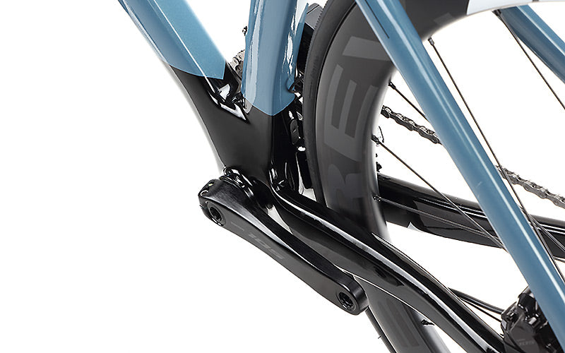 Close-up of a Masi Bikes EVOLUZIONE 1 Carbon road bike, emphasizing the rear wheel section. The photo showcases its sleek, aerodynamic design and features a black crank arm on the frame alongside a wheel with partly visible tire and spokes.
