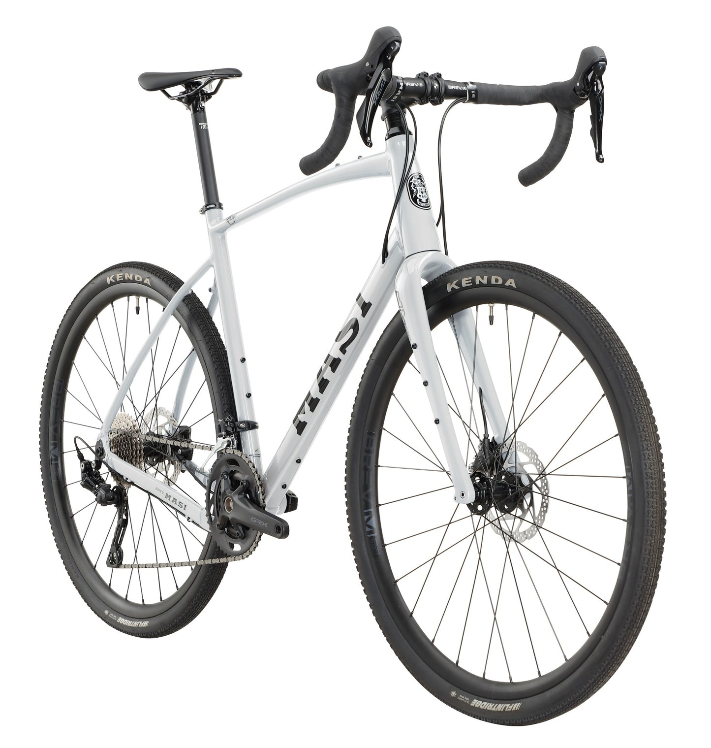 The BRUNELLO 1 is a white gravel bike with an alloy frame, drop bars, disc brakes, and wide Kenda tires in a front-side view.