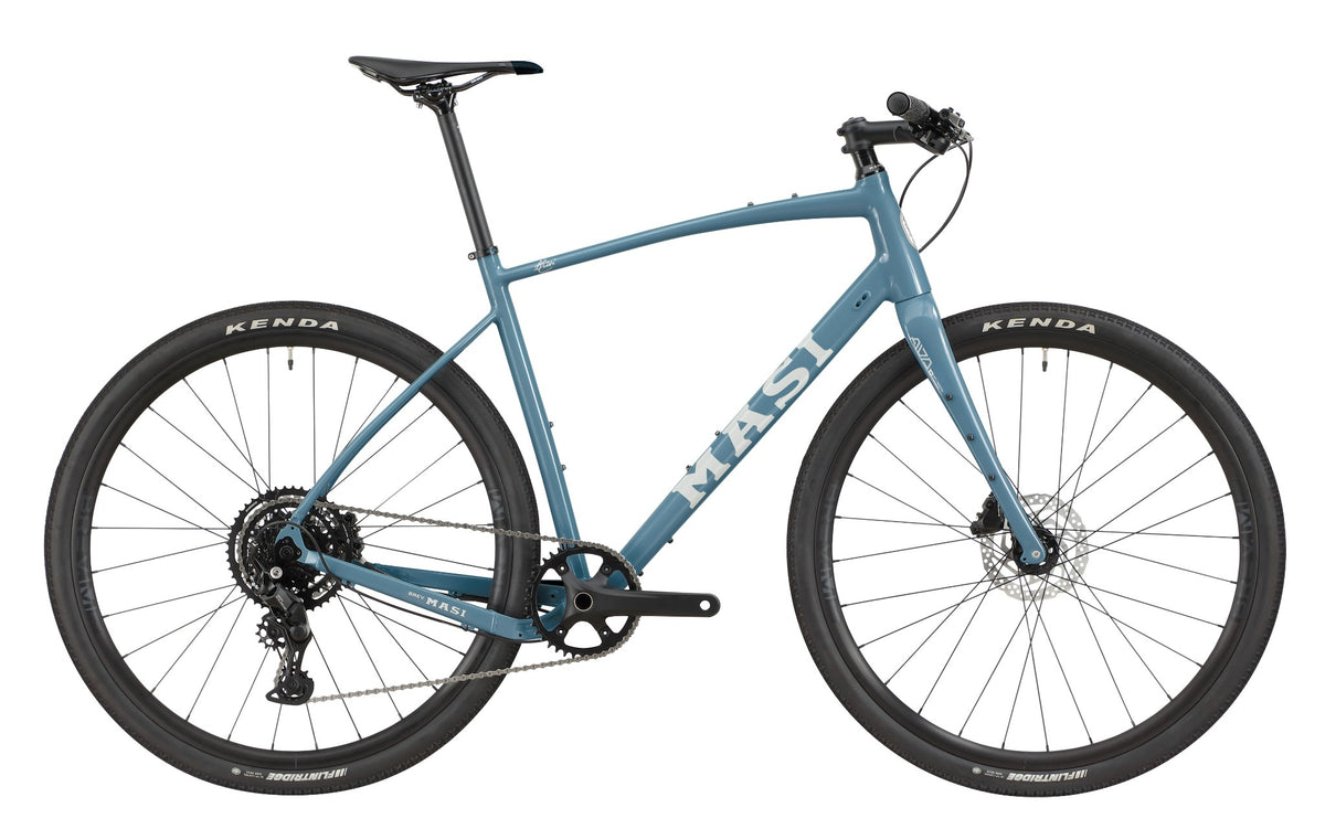 The BRUNELLO 3 is a blue Masi gravel bike with a light alloy frame, disc brakes, tubeless-ready wheels, and a flat handlebar.