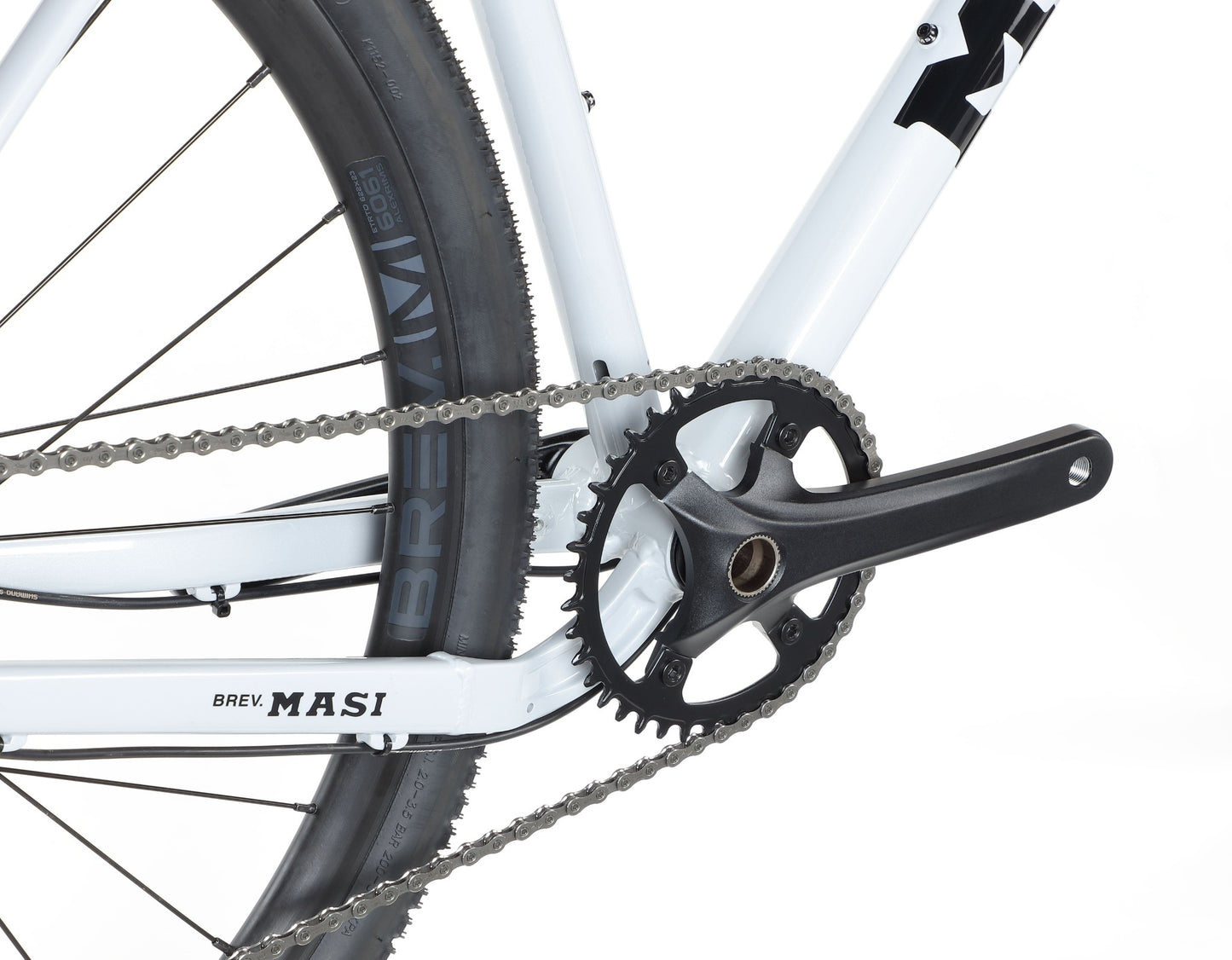Close-up of the BRUNELLO 3s crankset, chainring, and BREVM tubeless-ready rear wheel with a lightweight alloy frame.