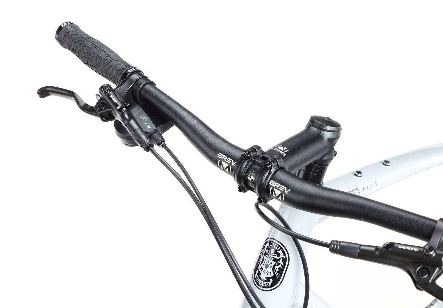 Close-up of BRUNELLO 3 black mountain bike handlebars with brake levers, cables, and lightweight alloy frame visible.
