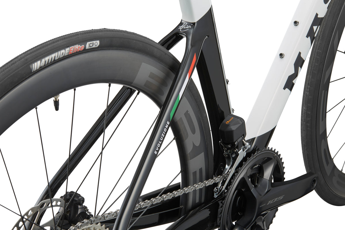 Close-up of the EVOLUZIONE 1 frame, showcasing its aerodynamic design with rear tire, chain, and Italian flag detail.