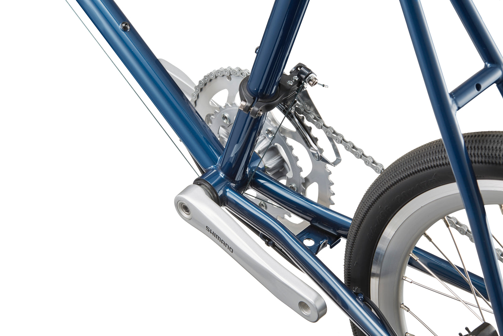 Close-up of the STELVIO 1 blue MiniVelo frame featuring crankset, pedals, chain, and a white-tired rear wheel—urban perfect.