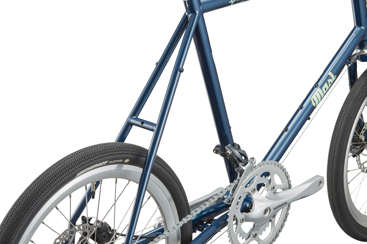 Close-up of the STELVIO 1: blue MiniVelo frame, rear wheel, pedals, and chainring—urban-ready with detailed tubing.