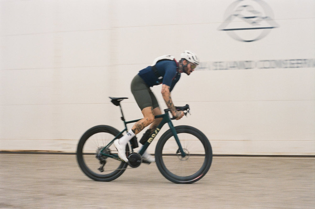 An Oltre Strada at speed, panned against a white wall