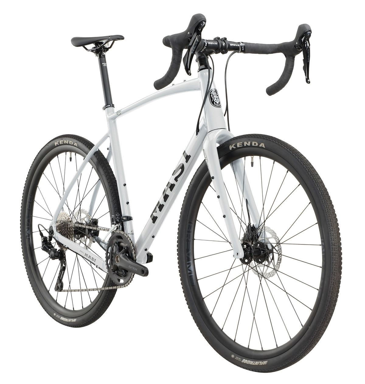 The BRUNELLO 1 is a white gravel bike with an alloy frame, drop bars, disc brakes, and wide Kenda tires in a front-side view.