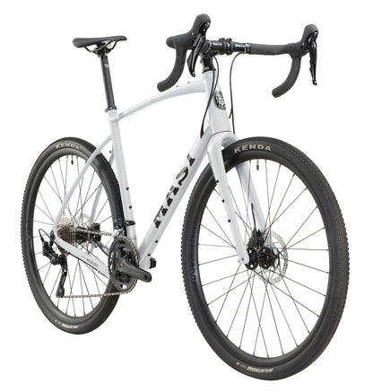The BRUNELLO 1 is a white gravel bike with an alloy frame, drop bars, disc brakes, and wide Kenda tires in a front-side view.