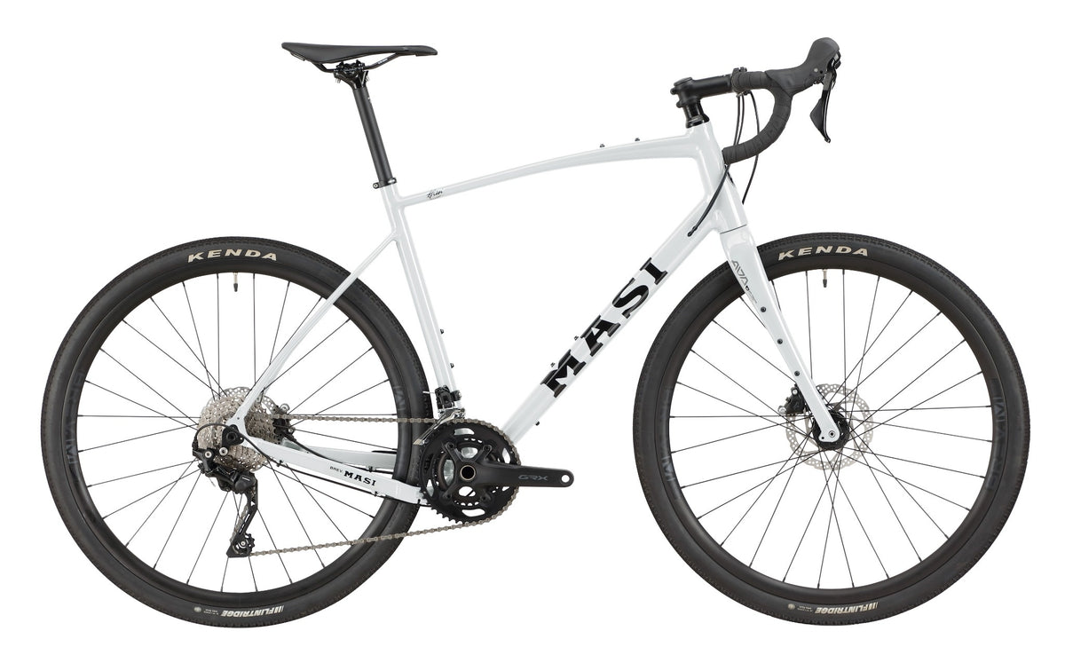 A white BRUNELLO 1 road bike with an alloy frame, drop bars, disc brakes, and black Kenda tires, shown in side view.