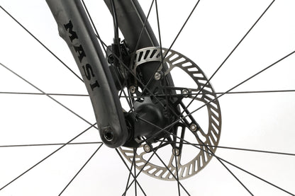 Close-up of an INCANTO CAMPY EKAR Ti bicycle wheel highlighting the detailed disc brake rotor and spokes. The brand Masi Bikes is visible on the dark front fork, with a Campagnolo EKAR 13-speed setup against a plain white background.